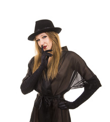 Fototapeta premium Beautiful young girl in black tunic, black hat and black gloves.