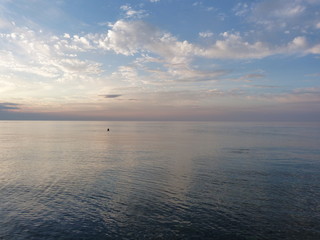 the fading pink sunset, the gathering twilight over the sea