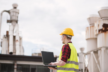 Construction worker or engineer using laptop