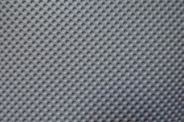 Top view of white material with embossed polka dots
