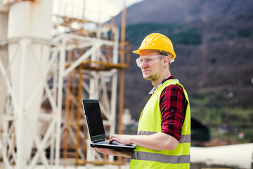 Construction worker or engineer using laptop