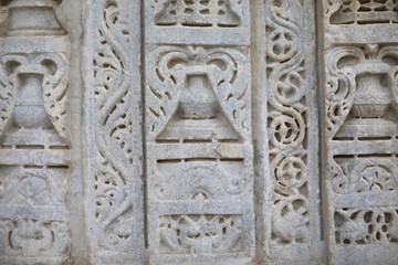 Fototapeta na wymiar Ancient Architectural Ornament, Stone Carving Decorations Inside Ranakpur Jain Temple in Rajasthan, India