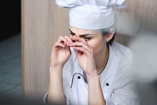 chef crying and sitting on floor at restaurant kitchen