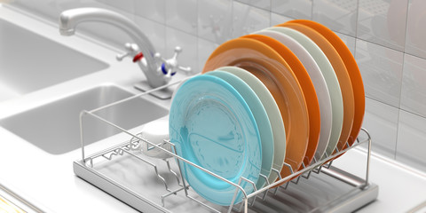 Dish drying rack with colorful plates on a white kitchen counter. 3d illustration