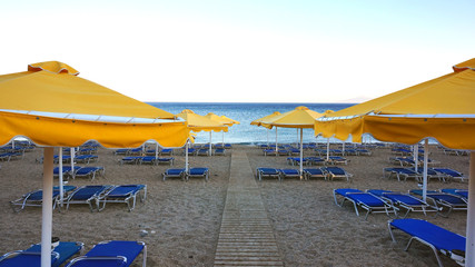 Fototapeta premium Beach with chairs and sunshades
