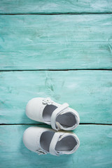 leather baby shoes on wooden surface