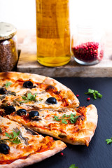 Homemade Napoli Pizza or anchovies pizza on black slate stone
