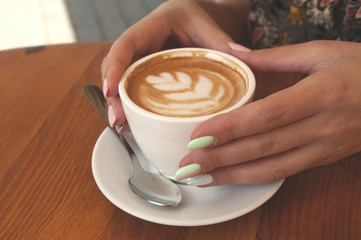 Close up of of coffee cup and hands.