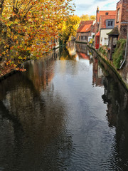 Canal of Bruges that surrounded by historical houses in Belgium