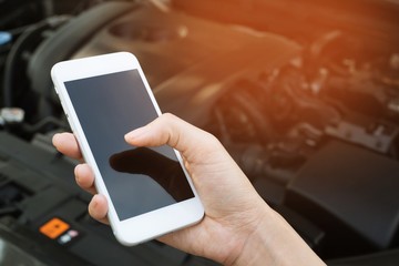 close up female hand using a mobile smart phone call a car mechanic ask for help assistance because car broken on the roadside. blank of empty screen.