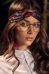 Naklejka premium Retro female model posing in eyeglasses.