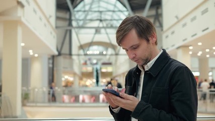 Close Up Of Man Reading Shopping List From Mobile Phone In Supermarket, man in shopping mall or airport terminal tourist