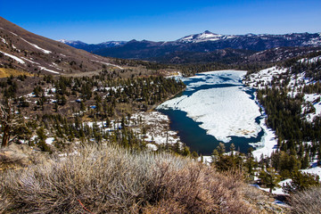 Fototapeta premium Melting Snow On Mountain Lake In Springtime