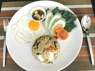 Fried Rice with basil squid and fried egg serve with Chille and Fish Sauce