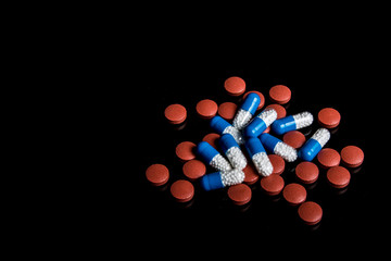Medical pills isolated on a black background