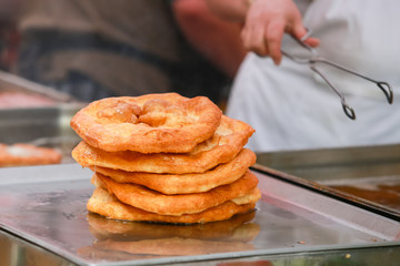 Baked johnnycake on a food stand ready for sale.