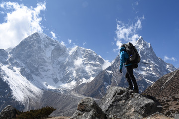 Trekker on the Everest Base Camp Trek in front of Mount Cholache and Mount Tabuche, Nepal