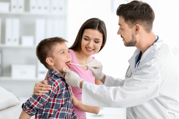 Fototapeta premium Children's doctor examining little boy in hospital