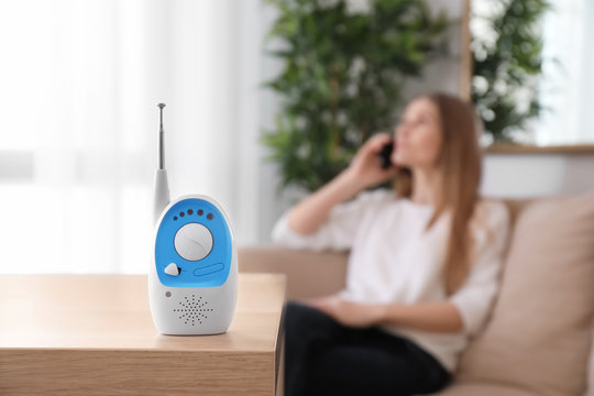 Baby monitor and woman on background. Radio nanny