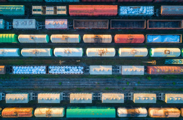 Aerial view of railway wagons. Cargo trains. Top view of colorful freight train on the railway...