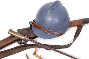 french military helmet of the First World War with rifle on white