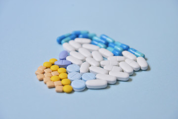Healthcare and medical series - heart shape of medicine pills, tablets and capsules on background