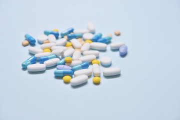 Healthcare and medical series - medicine pills, tablets and capsules on blue background