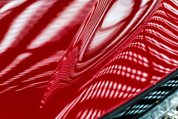 Abstraction of red metal surface of a modern car hood