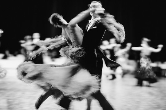 couple dancers ballroom dancing blurred motion black-and-white image