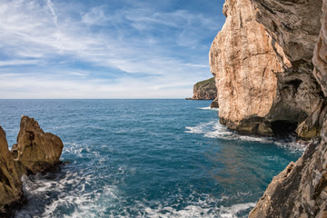Fototapeta na wymiar The rocky peninsula of Capo Caccia, with high cliffs, is located near Alghero; in this area there are the famous Neptune's Caves