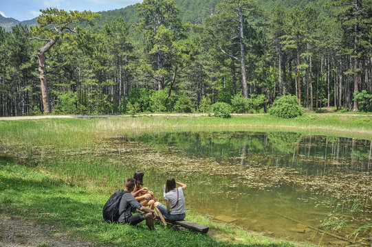tourists on the lake in the forest