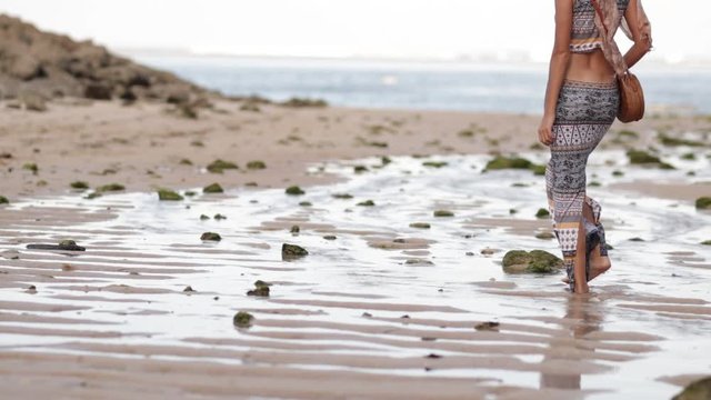 Woman with fashionable stylish rattan bag on the beach. Tropical island of Bali. Handmade Rattan eco handbag HD footage.