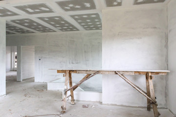 Empty room interior with gypsum board ceiling at construction site