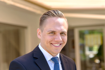 Fototapeta premium Smiling young businessman looking happy