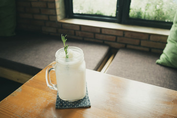 coconut water frappe with rosemary leaf on restaurant table