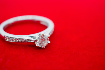 close up luxury wedding diamond ring on red background