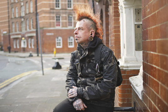 Portrait of tattooed man wearing ear plugs