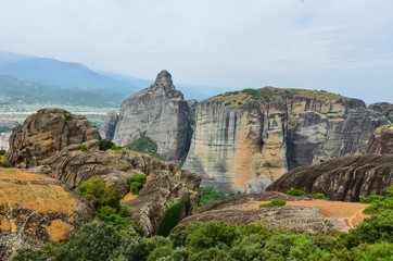 Fototapeta premium Greee, Meteora. Stunning spring panoramic landscape. View at mountains and green forest. Unesco heritage list object.