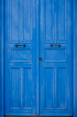 Blue door in Mediterranean style. Traditional greek door in Cyprus. Vintage background, texture. Copy space