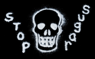 white sugar crystals forming a skull on a black background with text 'stop sugar'.