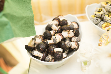 Delicious and tasty dessert table with cupcakes shots at reception closeup