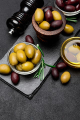 black and green olives and oil on stone serving board