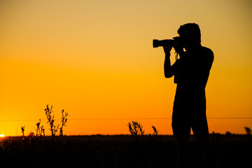  Silhouette of young photographer