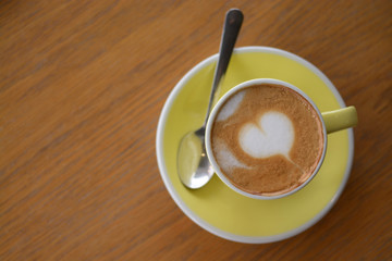 Cup of cappuccino coffee on table in cafe