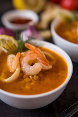 Lentil soup with seafood. Red soup with shrimps and squid, copy space
