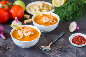Lentil soup with seafood. Red soup with shrimps and squid, copy space