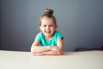 cute smiling girl sitting table