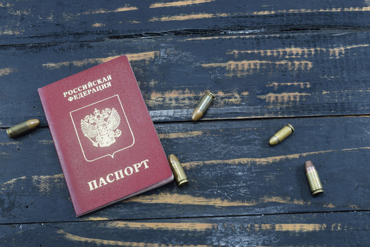 War with Russia, Russian passport on the table and ammunition