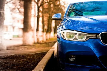 luxury blue car front view. sunlight