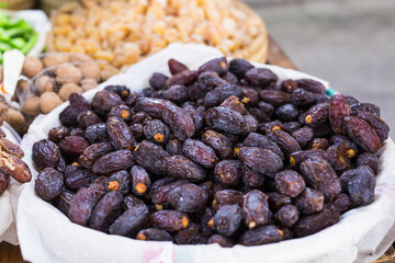 Fresh dates in a market - healthy lifestyle, food and fruit concept